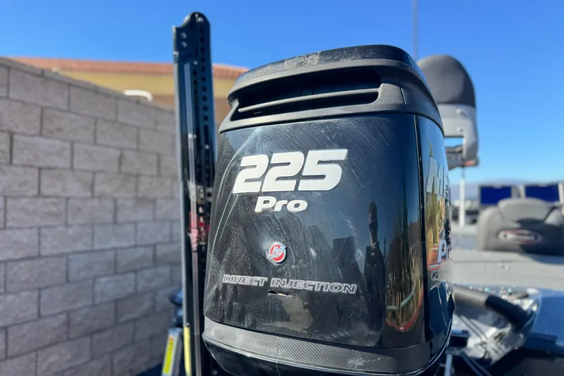 Slide: The Image of 2018 Triton 19 TrX Patriot with 225 Pro Direct Injection engine, outdoor setting. - 7