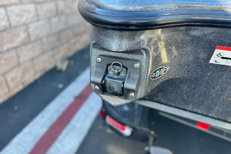 Slide: The Image of Close-up of 2018 Triton 19 TrX Patriot boat detail with safety pin and sticker. - 9