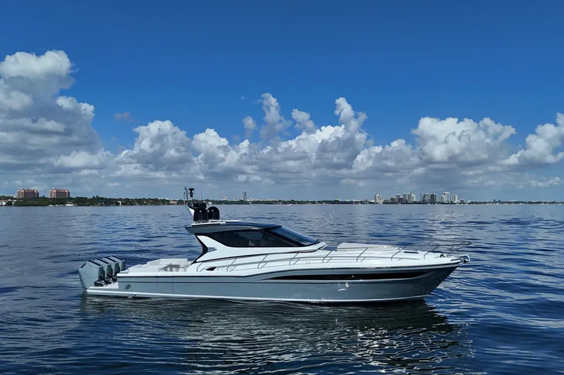 The Image of 2024 Uniesse HTC5P yacht cruising on calm waters under a clear blue sky. - 0