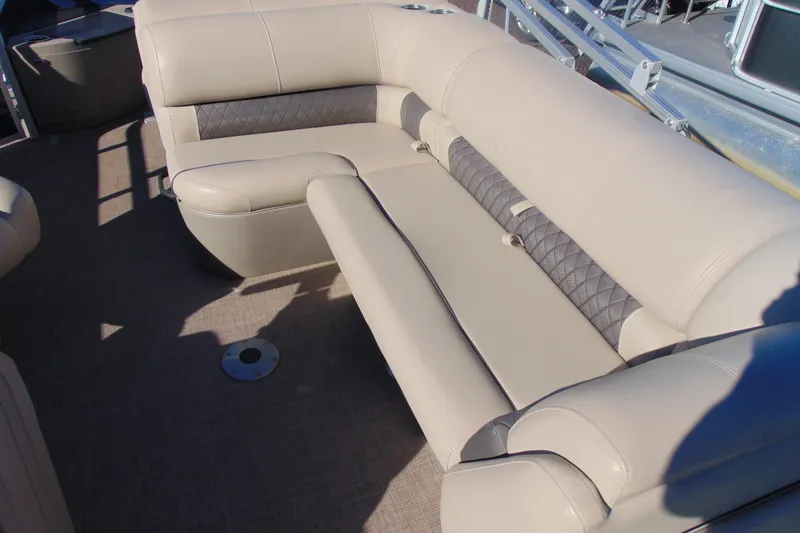 Slide: The Image of 2024 Sun Tracker Fishin' Barge 20 DLX interior seating with beige upholstery and diamond-pattern accents. - 10