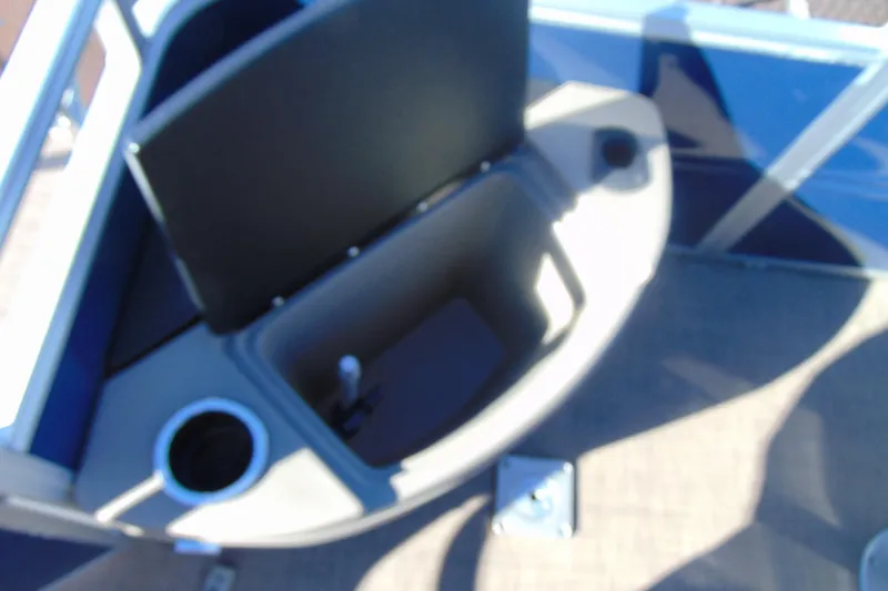 Slide: The Image of 2024 Sun Tracker Fishin' Barge 20 DLX interior storage compartment with cup holder. - 14