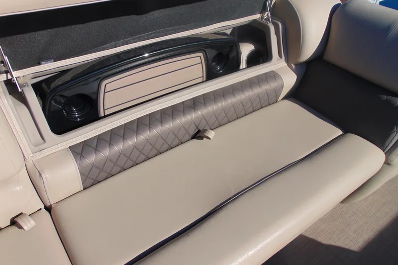 Slide: The Image of 2024 Sun Tracker Fishin' Barge 20 DLX seating with storage compartment open. - 18