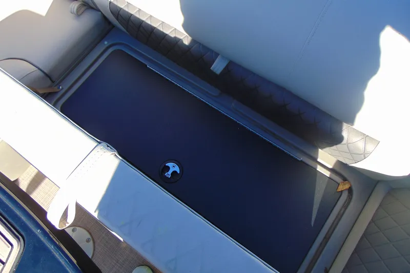 Slide: The Image of 2024 Sun Tracker Fishin' Barge 20 DLX storage compartment with cushioned seating. - 22