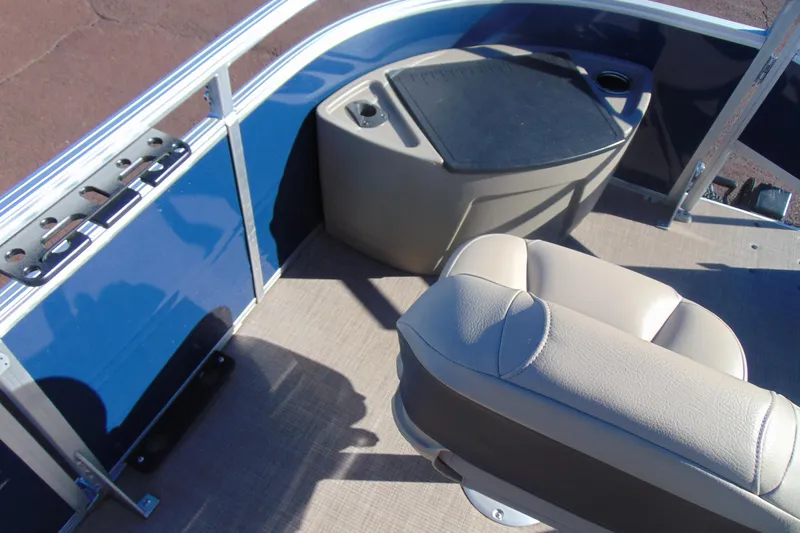 Slide: The Image of 2024 Sun Tracker Fishin' Barge 20 DLX interior with seating and storage. - 25