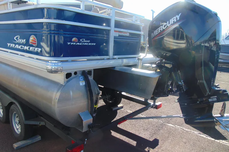 Slide: The Image of 2024 Sun Tracker Fishin' Barge 20 DLX with Mercury outboard motor on trailer. - 4