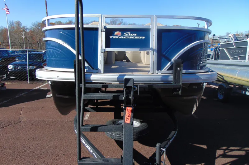Slide: The Image of 2024 Sun Tracker Fishin' Barge 20 DLX pontoon boat on trailer, rear view. - 6