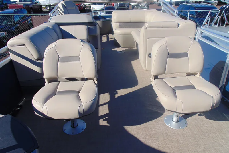 Slide: The Image of 2024 Sun Tracker Fishin' Barge 20 DLX interior with beige seating and spacious layout. - 7