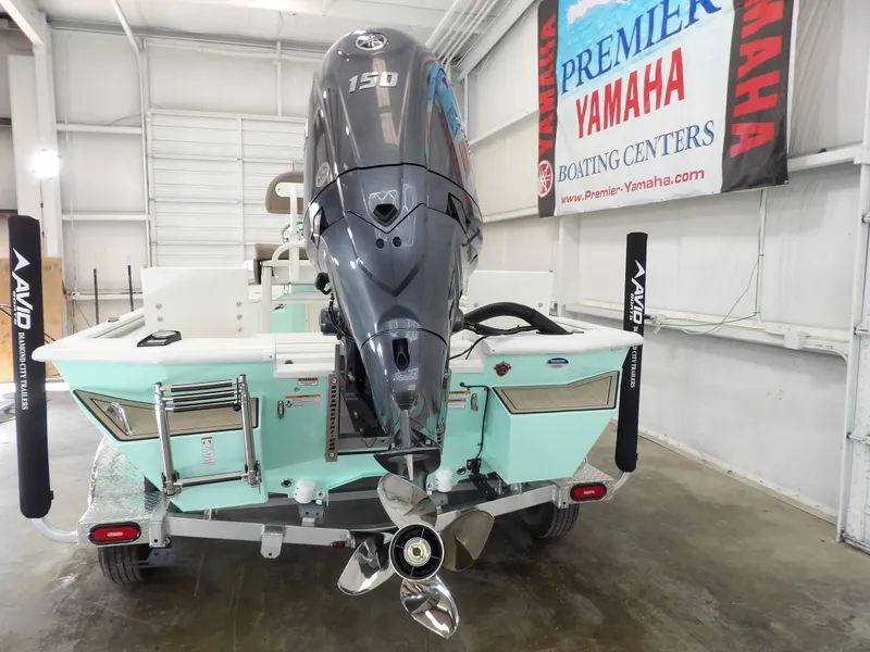 Slide: The Image of 2026 Avid 21FST boat with Yamaha 150 engine in showroom. - 11