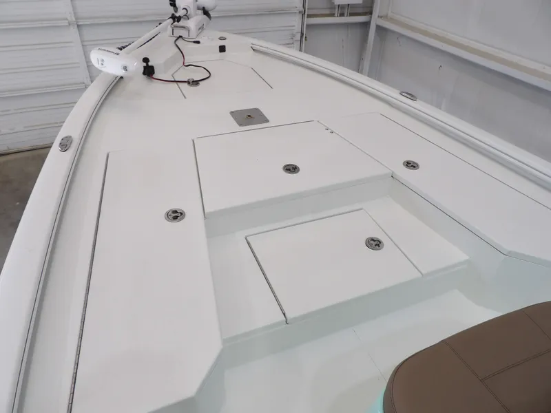 Slide: The Image of 2026 Avid 21FST boat deck with storage compartments and trolling motor. - 12
