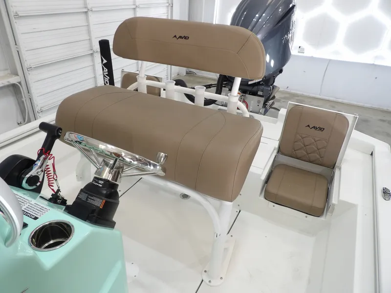 Slide: The Image of Avid 21FST boat interior with tan seating and steering wheel, 2026 model. - 17