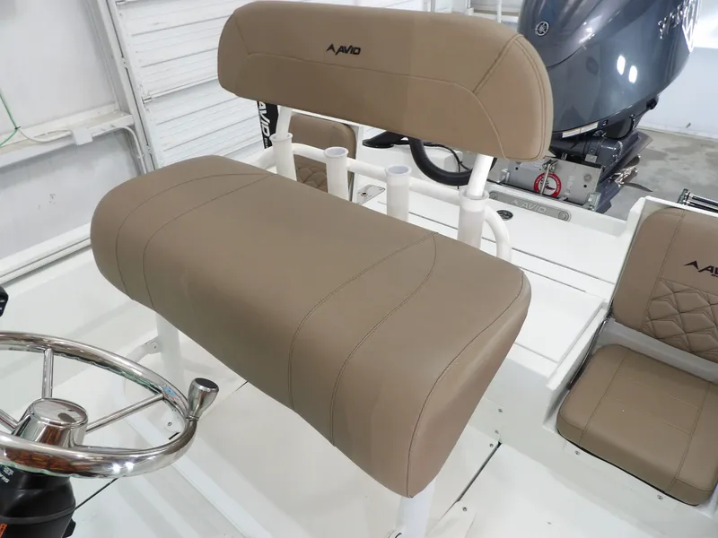Slide: The Image of Avid 21FST 2026 boat interior with tan seating and steering wheel. - 19