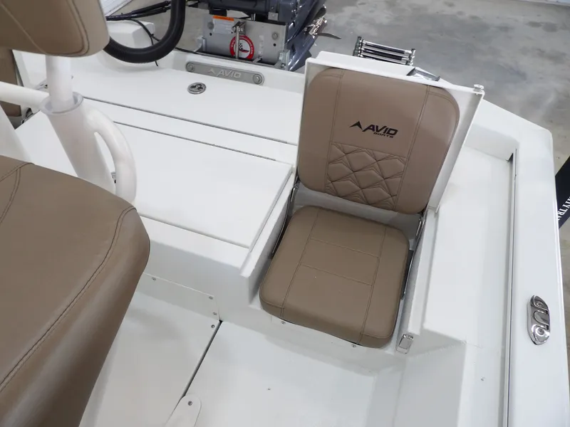 Slide: The Image of 2026 Avid 21FST boat interior with tan cushioned seating and steering wheel. - 20