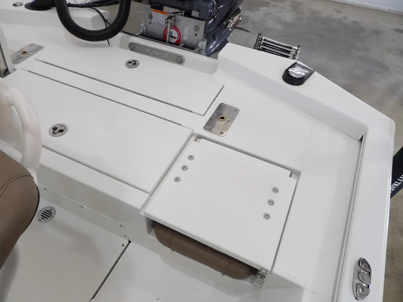 Slide: The Image of Avid 21FST 2026 boat deck with storage compartments and steering wheel. - 21