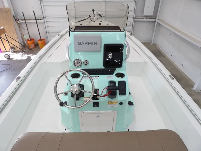 Slide: The Image of Avid 21FST 2026 boat console with Garmin navigation system in a garage setting. - 23