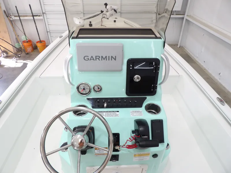Slide: The Image of Avid 21FST 2026 boat console with Garmin navigation, steering wheel, and controls. - 25