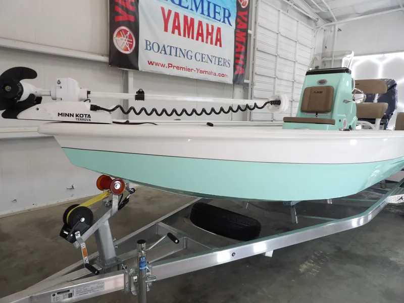 Slide: The Image of 2026 Avid 21FST boat on trailer, featuring Minn Kota Terrova motor, in showroom. - 3
