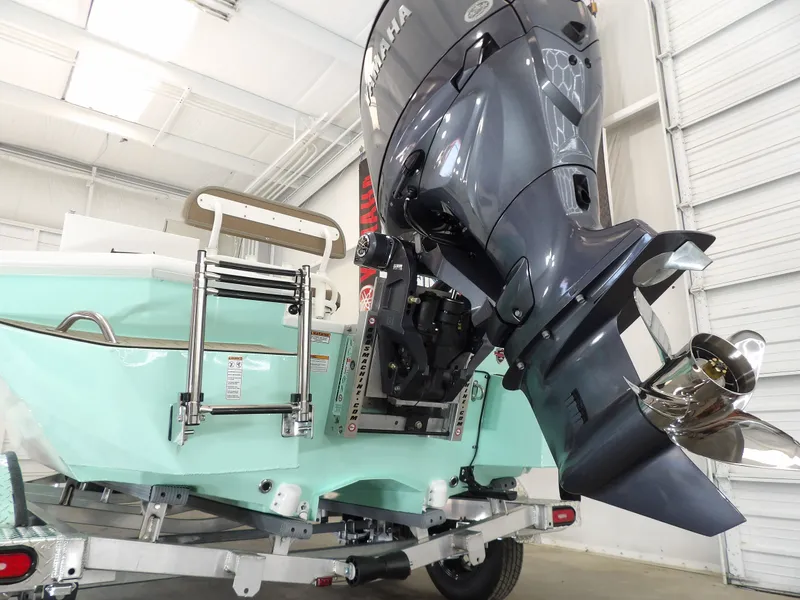 Slide: The Image of Avid 21FST 2026 boat with Yamaha outboard motor in a showroom. - 9