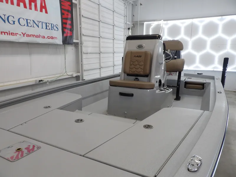 Slide: The Image of 2026 Avid 21FST boat interior with console and seating in showroom. - 10