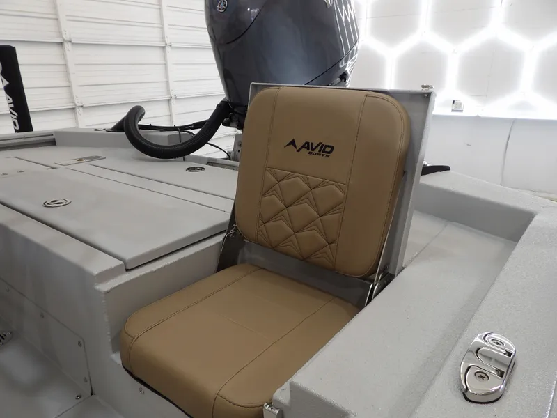 Slide: The Image of Avid 21FST 2026 boat seat with tan upholstery and logo in a modern interior. - 17