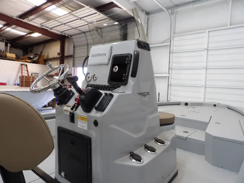 Slide: The Image of 2026 Avid 21FST boat console with Garmin navigation in a garage setting. - 21