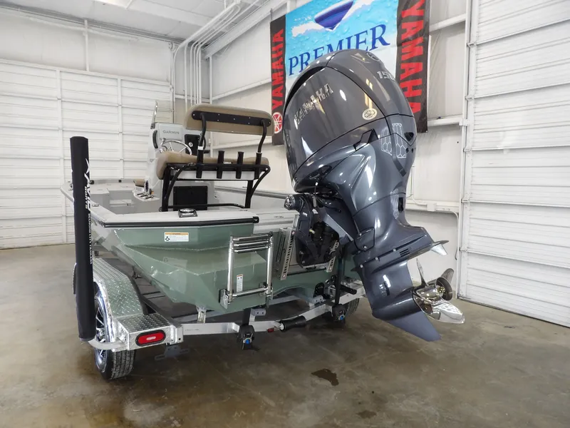 Slide: The Image of 2026 Avid 21FST boat with Yamaha outboard motor in a showroom. - 6