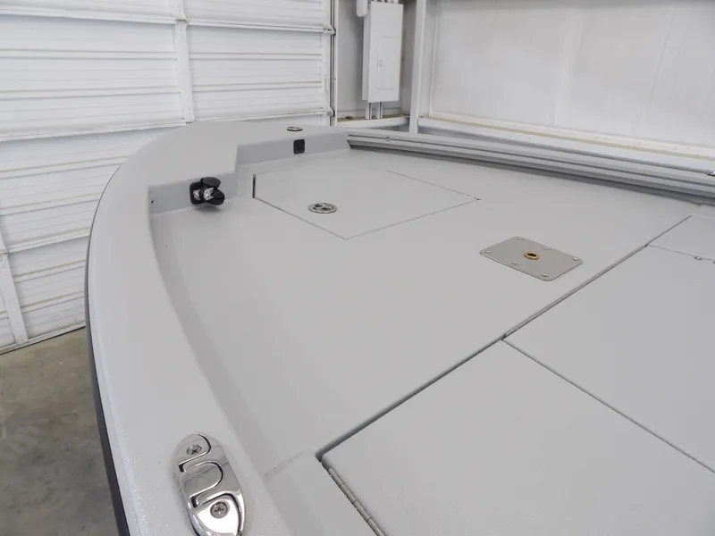 Slide: The Image of 2026 Avid 21FST boat deck with storage compartments in a garage setting. - 9