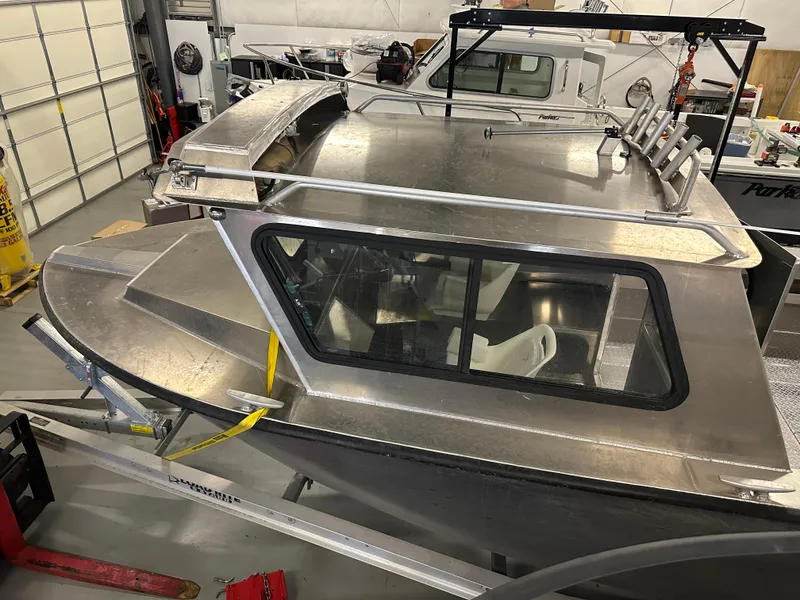 Slide: The Image of 2025 Northshore 24 boat in a workshop, showcasing sleek design and modern features. - 12