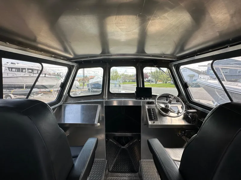 Slide: The Image of Interior of 2025 Northshore 24 boat, featuring modern steering and seating. - 18