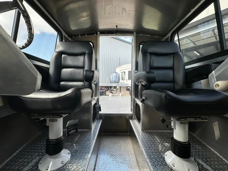 Slide: The Image of Interior of 2025 Northshore 24 boat with two black leather seats. - 21