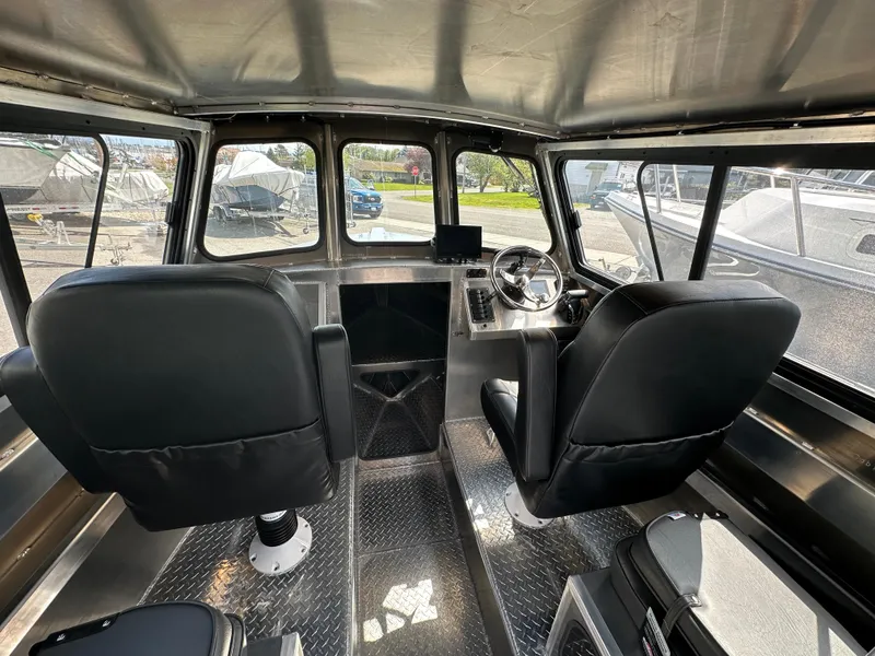 Slide: The Image of Interior of 2025 Northshore 24 boat with modern steering and seating. - 22
