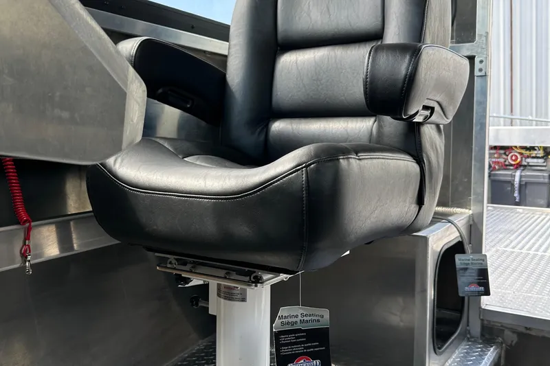 Slide: The Image of Captain's chair in a 2025 Northshore 24 boat, featuring sleek black leather upholstery. - 23