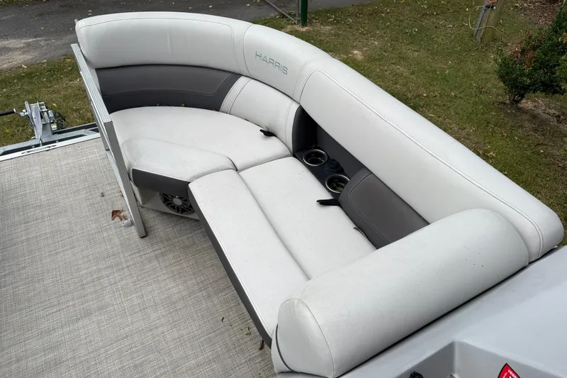 Slide: The Image of Luxurious seating on 2021 Harris Cruiser 210 pontoon boat, featuring cup holders and premium upholstery. - 14