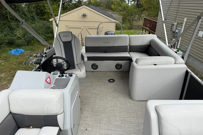 Slide: The Image of 2021 Harris Cruiser 210 pontoon boat interior with gray seating and steering console. - 16