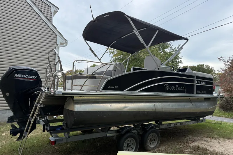 Slide: The Image of 2021 Harris Cruiser 210 pontoon boat on trailer with Mercury outboard motor. - 4