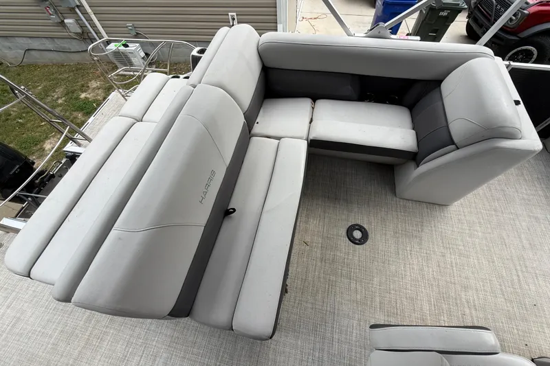 Slide: The Image of 2021 Harris Cruiser 210 boat interior with gray seating and spacious layout. - 9