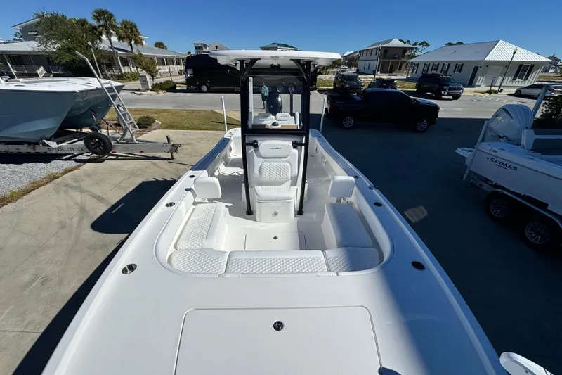 Slide: The Image of 2026 Caymas 28 HB boat with sleek design, docked in a sunny marina. - 11