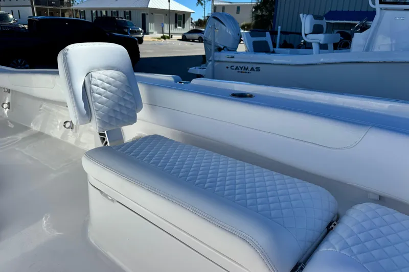 Slide: The Image of 2026 Caymas 28 HB boat interior with quilted white seating and modern design. - 17