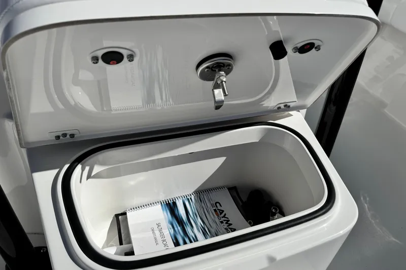 Slide: The Image of Open storage compartment on 2026 Caymas 28 HB boat with manuals inside. - 20
