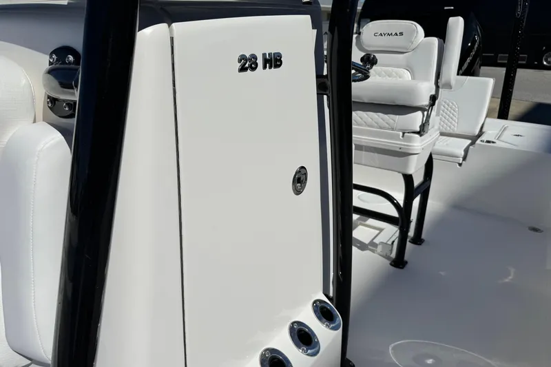 Slide: The Image of 2026 Caymas 28 HB boat interior with white seating and sleek design. - 22