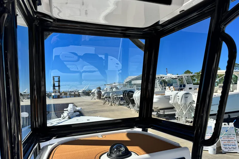 Slide: The Image of Interior view of 2026 Caymas 28 HB boat with marina in background. - 24