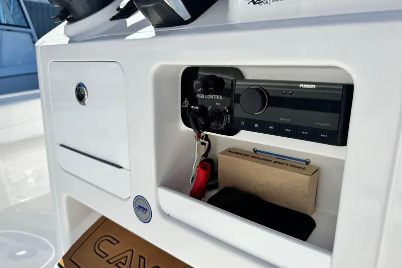 Slide: The Image of 2026 Caymas 28 HB boat console with control panel and storage compartment. - 28