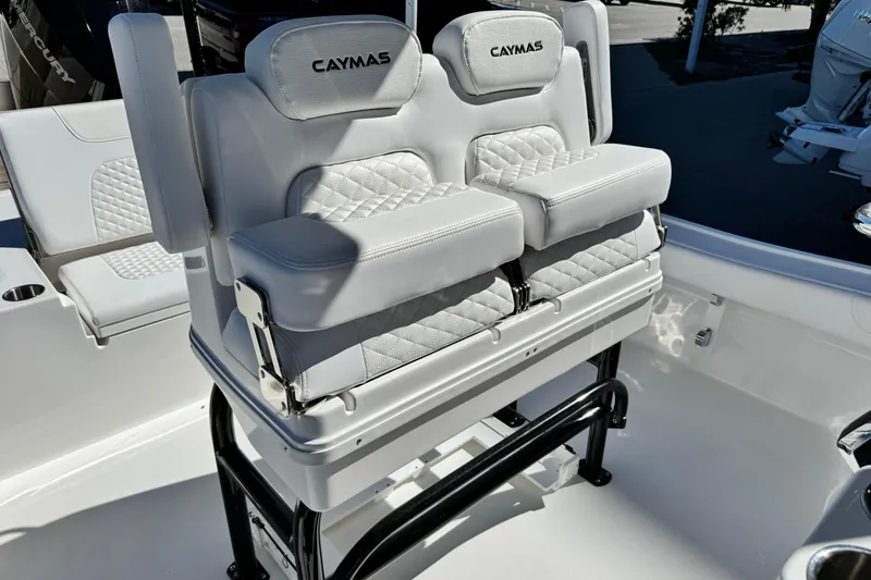 Slide: The Image of 2026 Caymas 28 HB boat seating with white cushioned design and branding. - 29