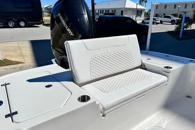 Slide: The Image of 2026 Caymas 28 HB boat with white cushioned seating and Mercury engine. - 31