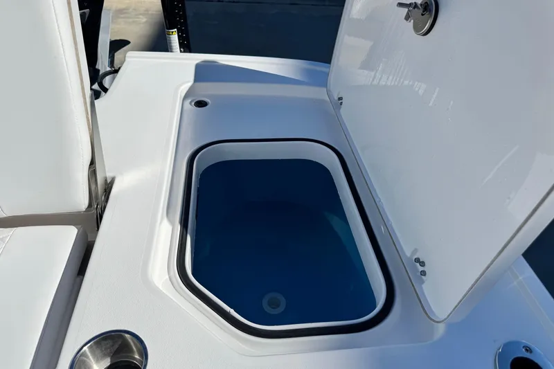 Slide: The Image of 2026 Caymas 28 HB boat livewell with open lid, showcasing interior design. - 33