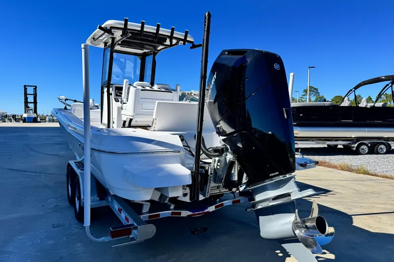Slide: The Image of 2026 Caymas 28 HB boat with powerful outboard motor on trailer. - 5