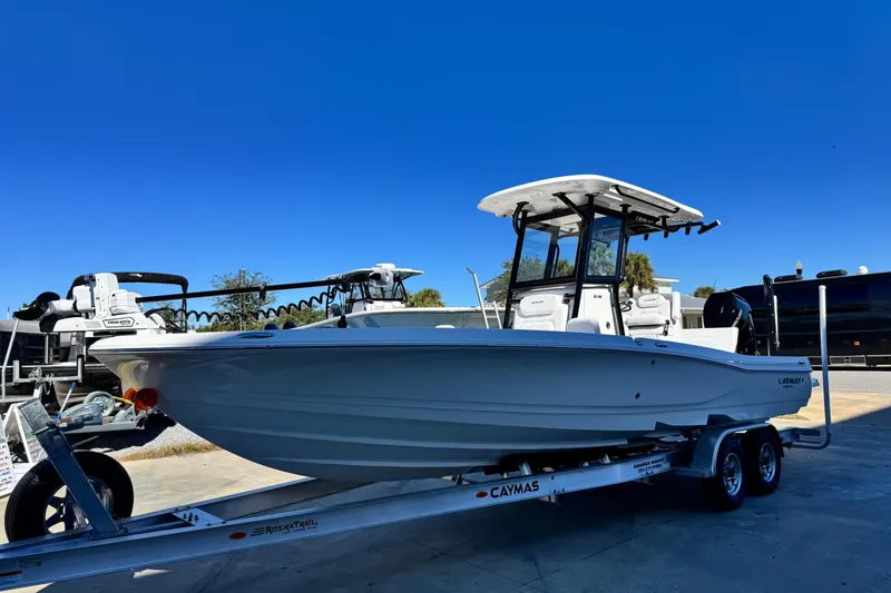 Slide: The Image of 2026 Caymas 28 HB boat on trailer under clear blue sky. - 7