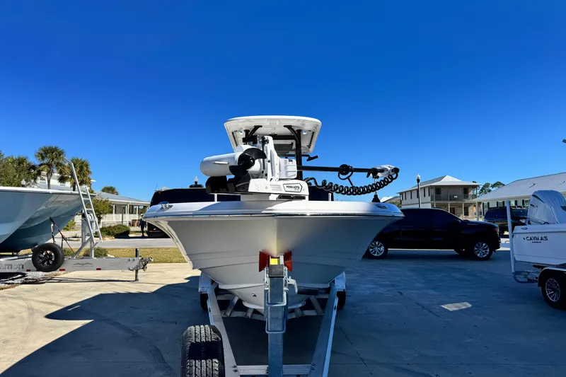 Slide: The Image of 2026 Caymas 28 HB boat on trailer under clear blue sky. - 8