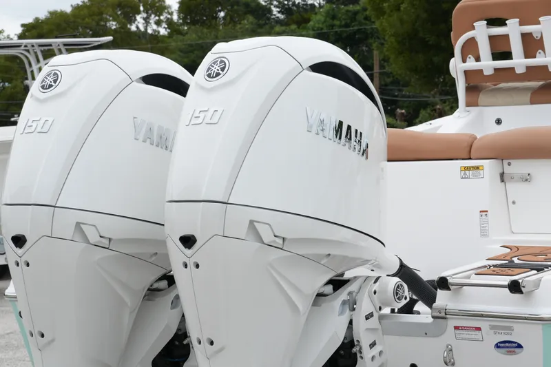 Slide: The Image of 2025 NauticStar 252 Legacy with dual Yamaha 150 engines, rear view. - 11