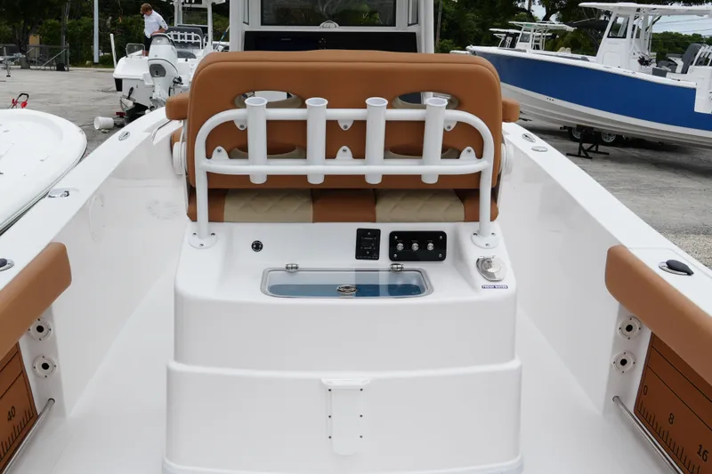 Slide: The Image of 2025 NauticStar 252 Legacy boat interior with rod holders and seating. - 14