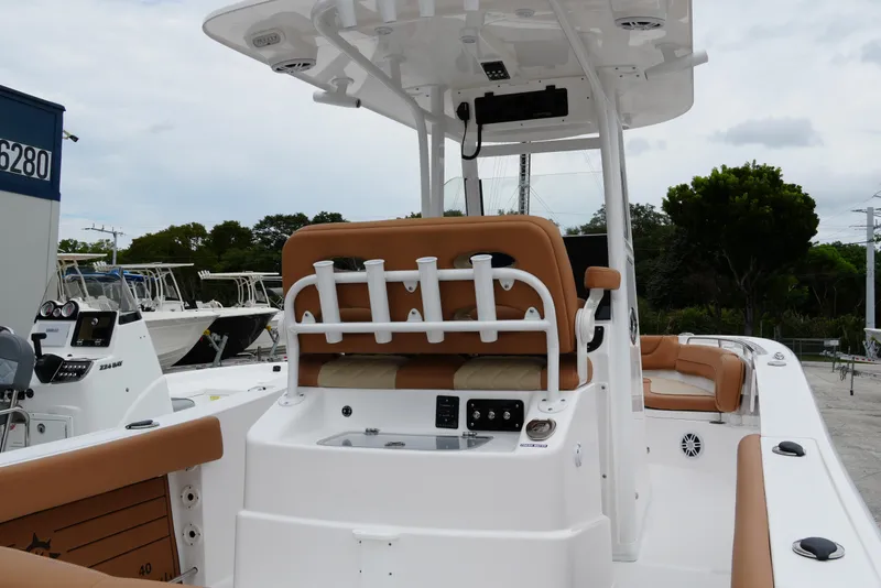 Slide: The Image of 2025 NauticStar 252 Legacy boat interior with tan seating and modern console. - 15